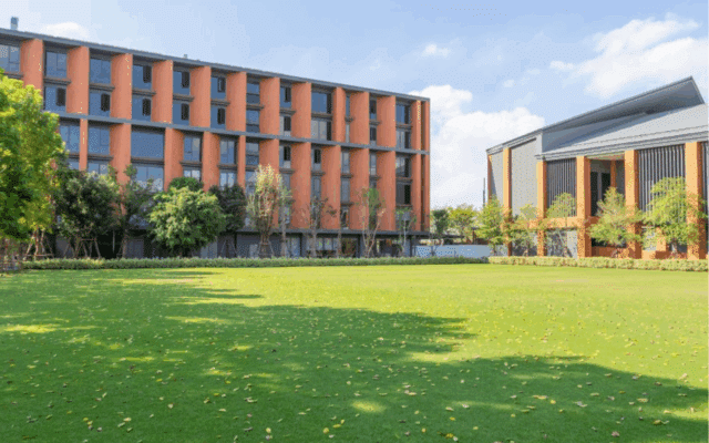 The modern campus and lawns of Wellington College International School Bangkok