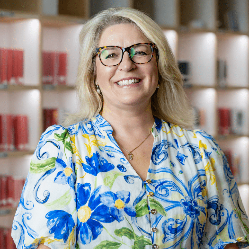 A woman smiling in a library