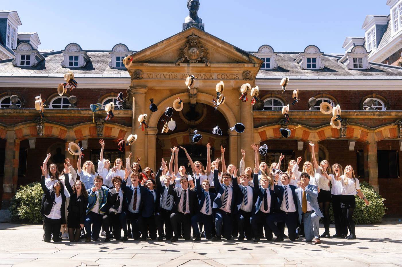 Wellington College students throwing their boater hats in the air on Speech Day