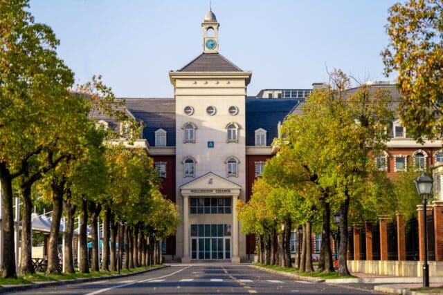 The main Hiba Academy Hangzhou building at the end of a tree-lined avenue