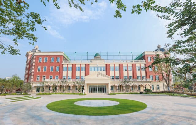 The red-brick main building and circular drive at Wellington College International Hangzhou
